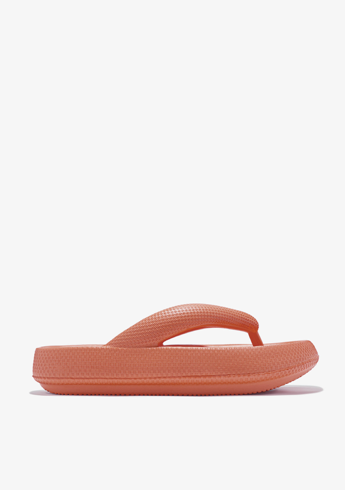 An orange sandal with EVA sole and toe position, inspired by the cliffs and sand of Ramla Bay.